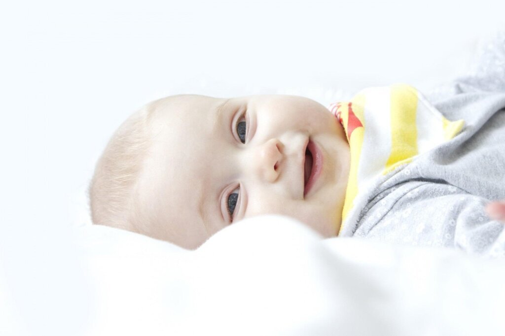 baby sleepwear being cleaned with lint remover