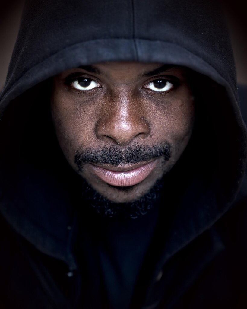 man using lint remover on hoodie at home