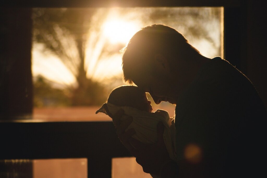 father and baby in clean bright kitchen morning