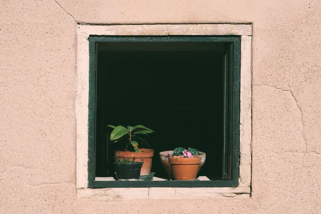calcium chloride dehumidifier placed on window sill with water collected