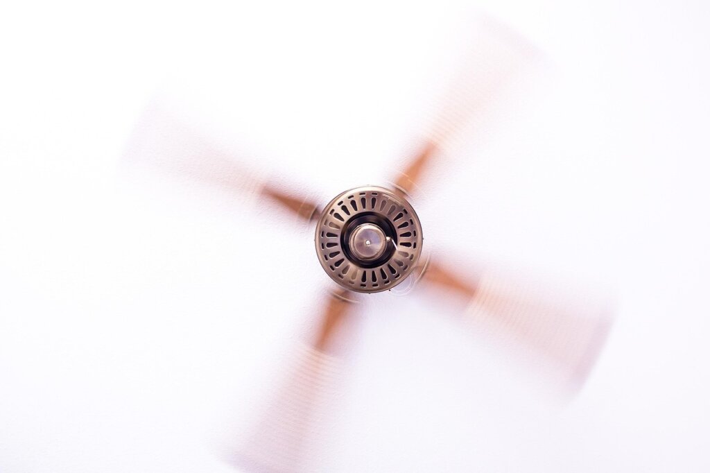 fan blowing air toward mattress indoors