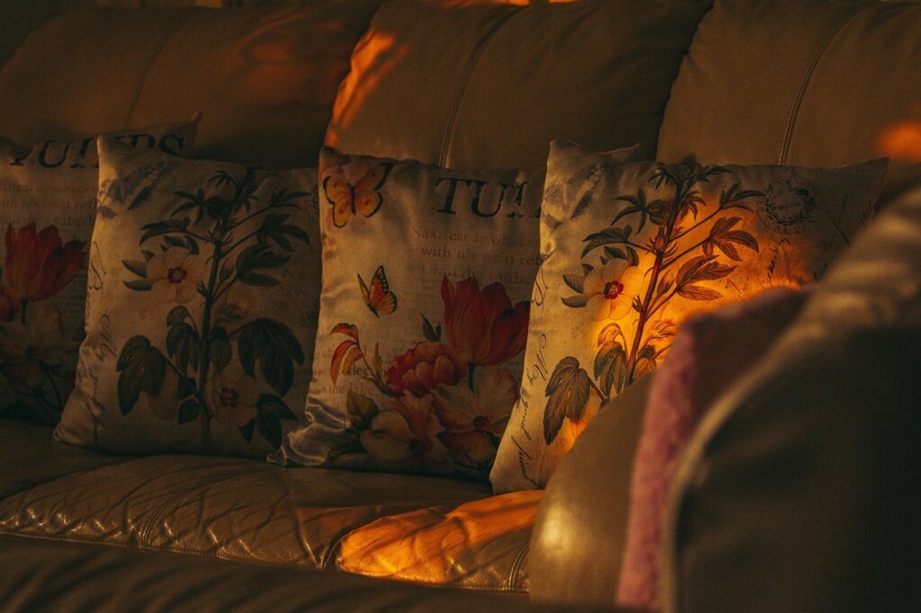 person applying leather conditioner on sofa with soft cloth, natural light