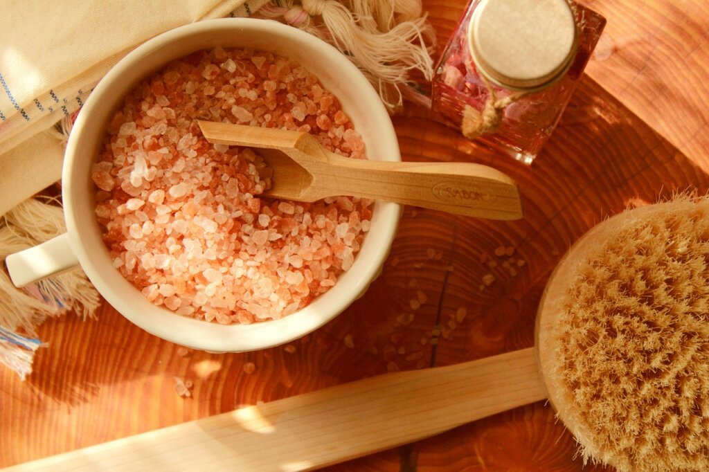 coarse salt and lemon on wooden cutting board scrubbing process
