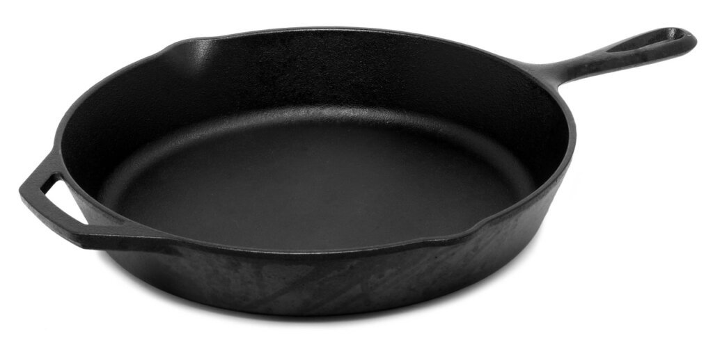cast iron skillet being scrubbed after baking soda treatment