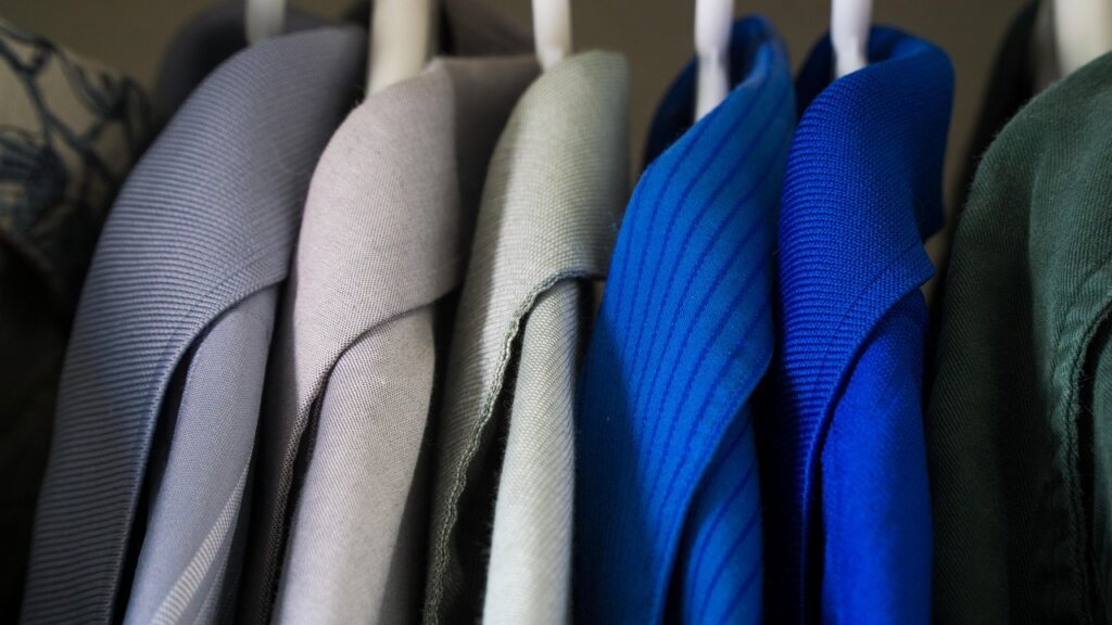 white shirts hanging in a well-ventilated wardrobe with fabric covers