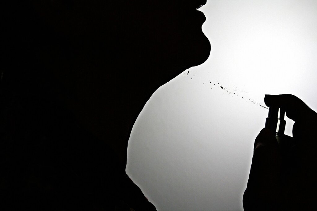 perfume mist sprayed in the air, man walking through fragrance cloud