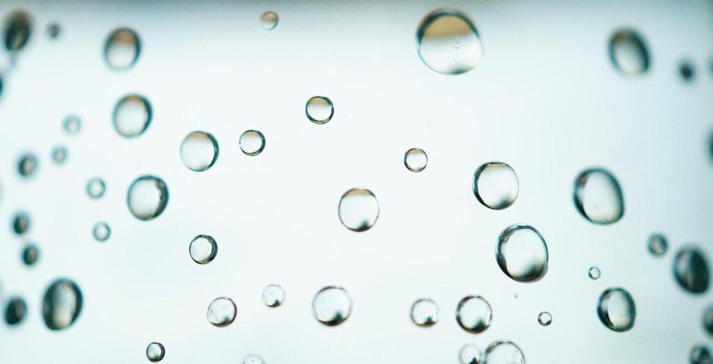egg floating test in clear glass of water kitchen background