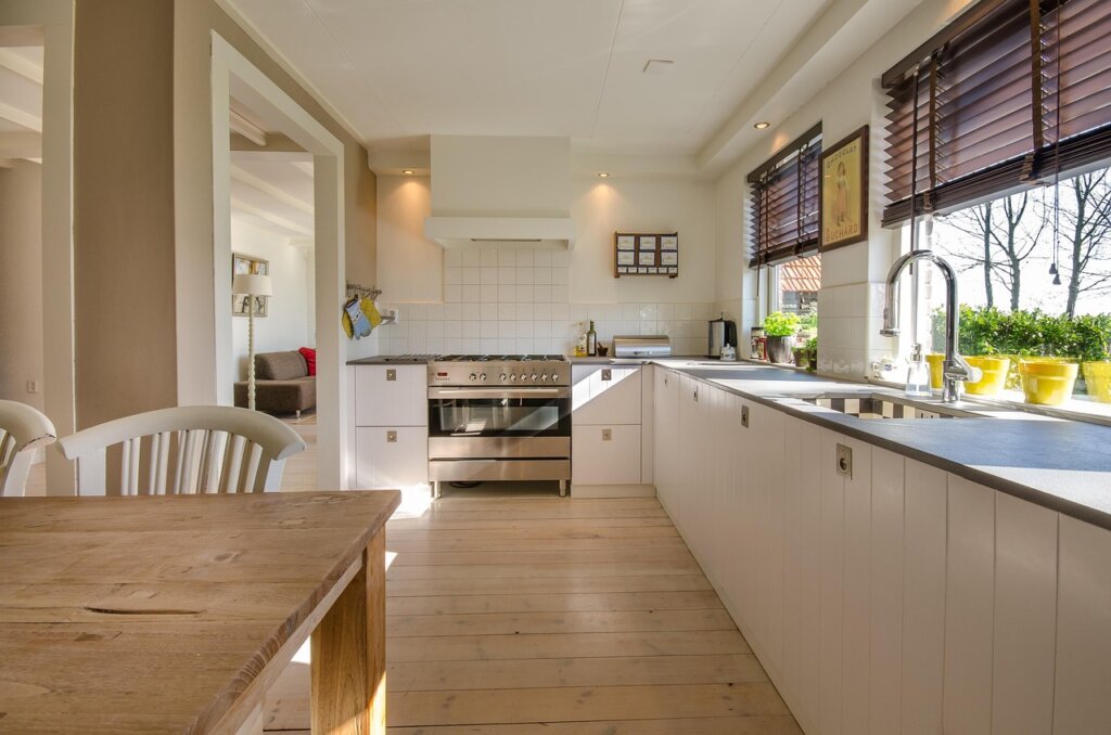 person dropping egg into glass of water on kitchen counter natural morning light