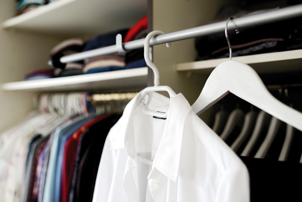 slim velvet hangers in row with pastel clothes hanging neatly
