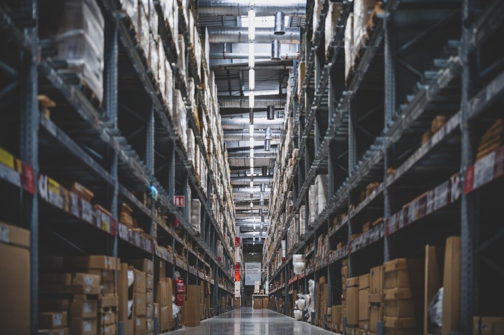 small business owner sorting styrofoam packaging in a warehouse storage room