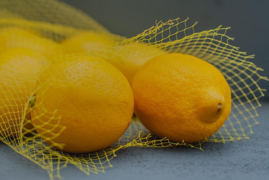 yellow curry stain on white plastic food container closeup