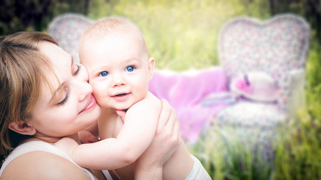 mother applying natural repellent on child arm outdoors