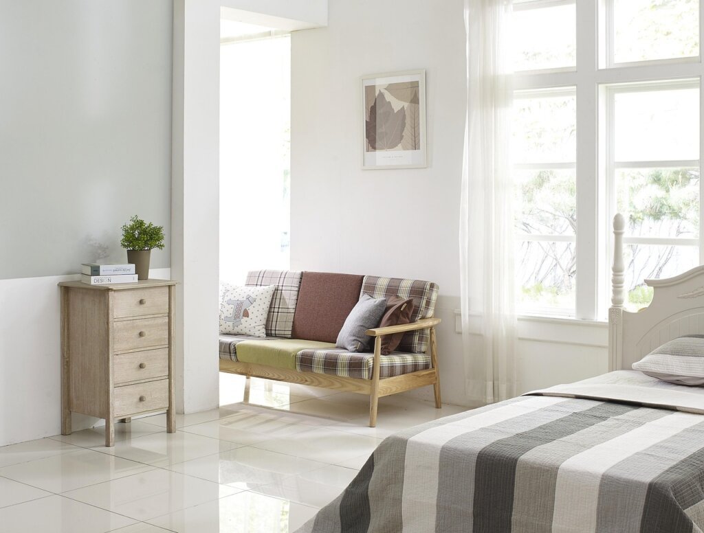 cat litter box placed near ventilated window in bright room