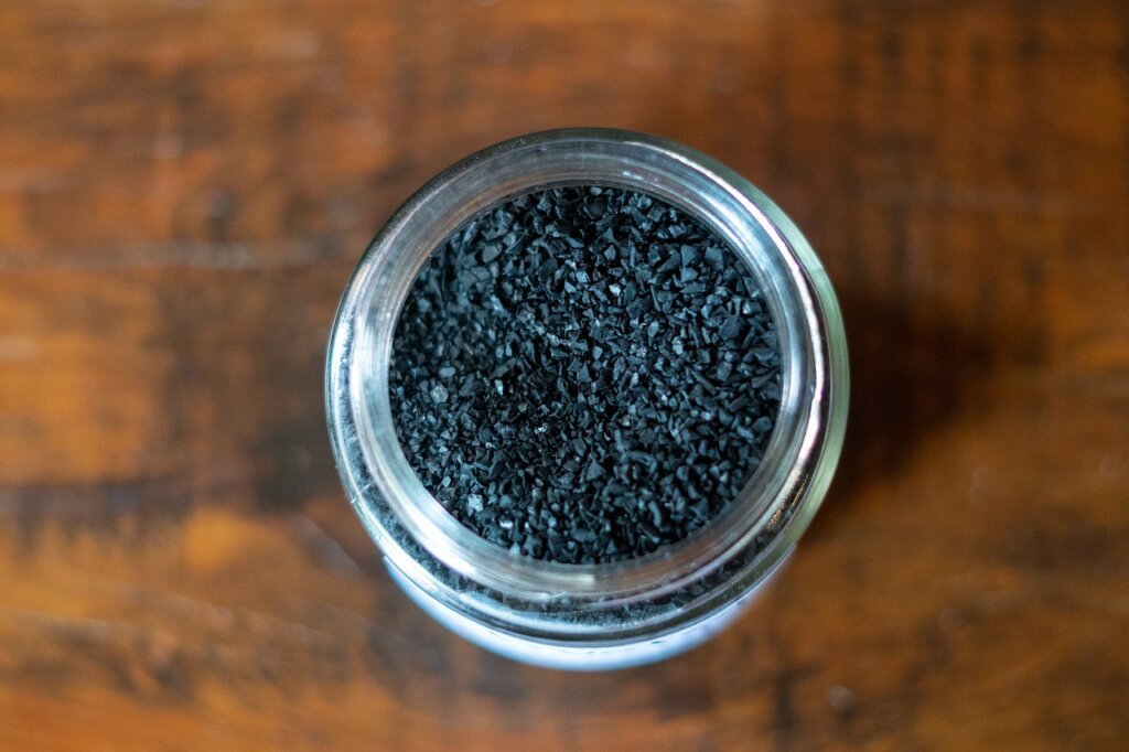 activated charcoal pieces in small bowl inside refrigerator