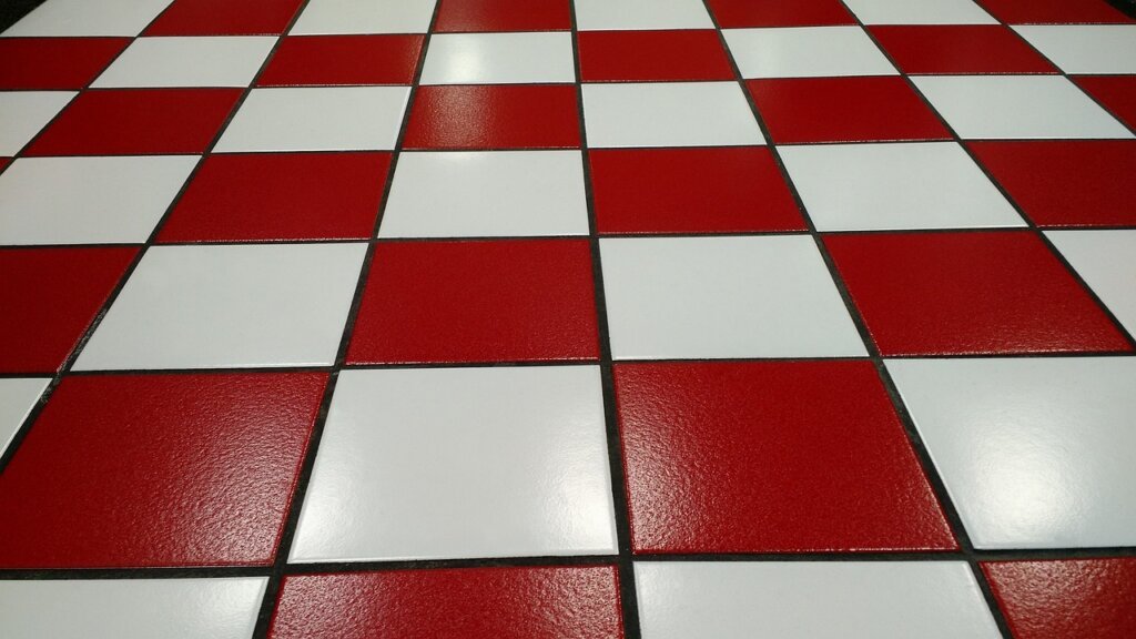 grout sealant coating application on white bathroom tiles