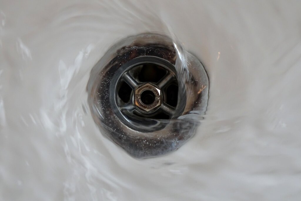 plastic bottle used as plunger on sink drain