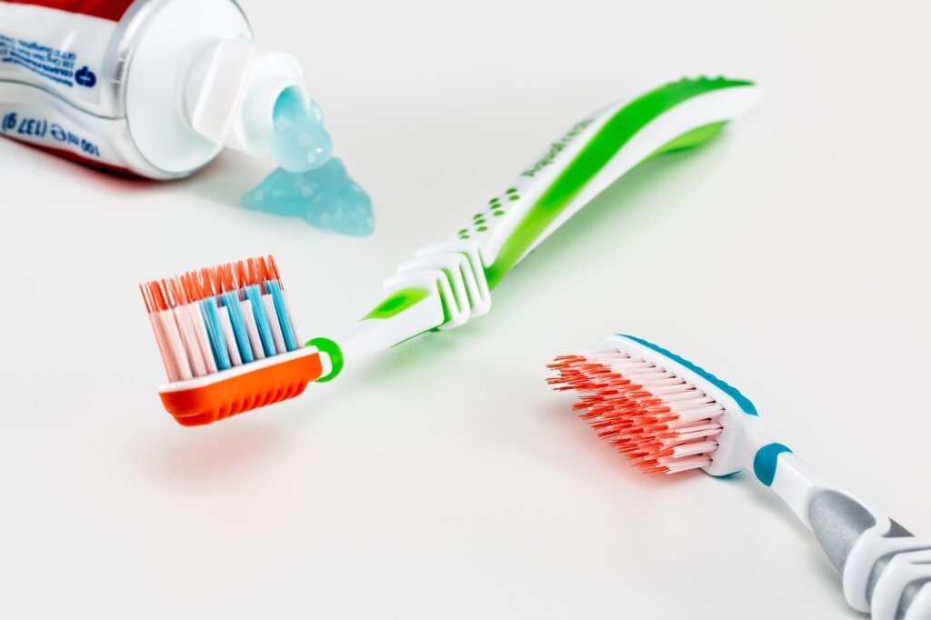 white cream toothpaste squeezed onto old toothbrush