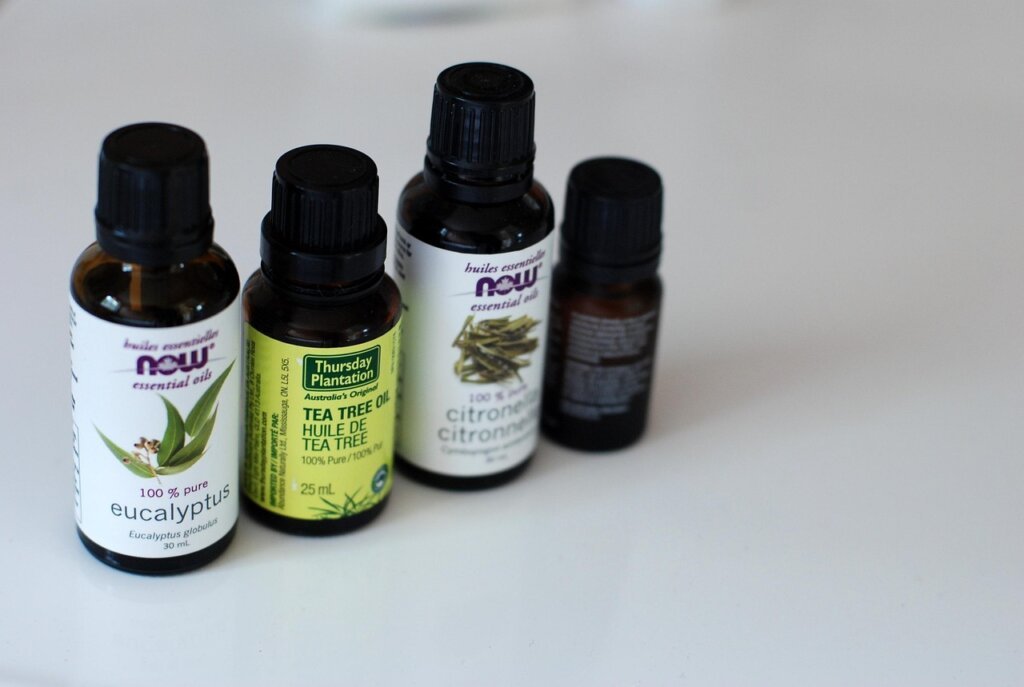 essential oils citronella lavender lemon eucalyptus arranged neatly on table