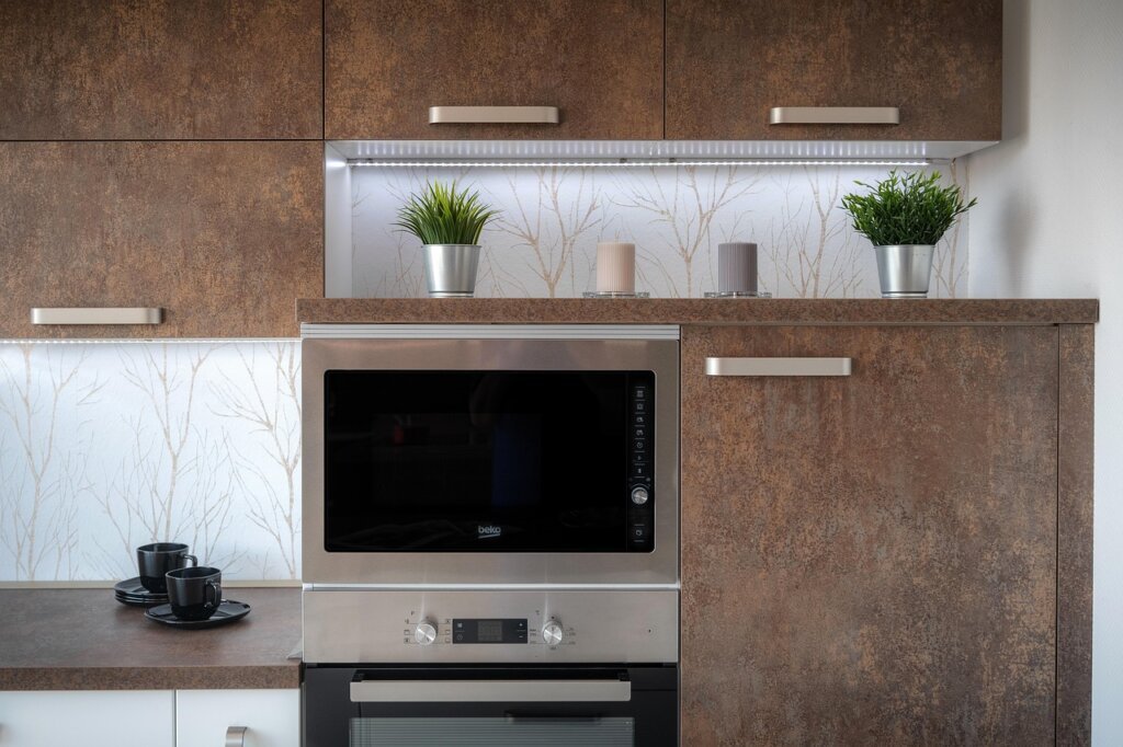microwave oven with cover placed over bowl of food before heating